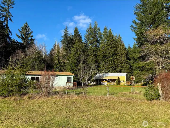 Partially fenced field near home & shops