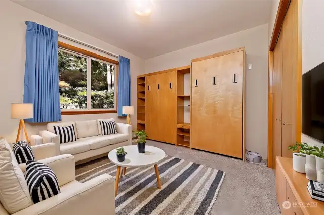 Virtually staged bedroom on the main floor with TWO built-in Murphy beds!