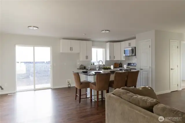 The updated kitchen offers refaced cabinetry, new x-large island, and striking oversized granite that with extra eating space.