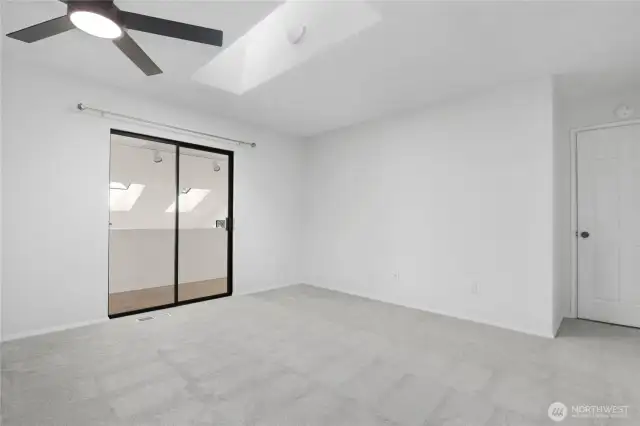 Primary bedroom showing sitting area and entry door on right.