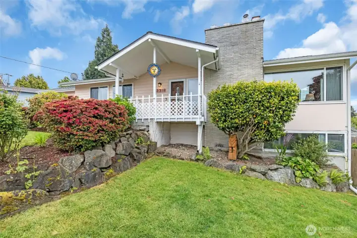 Landscaped front yard with access to west side entry and outdoor space