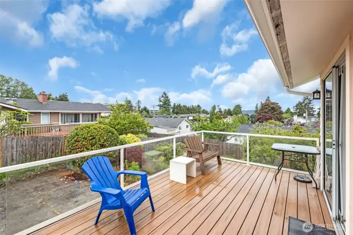 Enjoy the outdoors looking west to the water. Stairs lead to the upper back patio