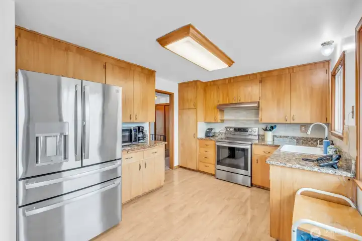 Updated kitchen with granite countertops and stainless steel.