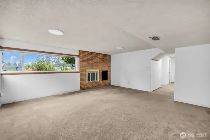 Lower level Family room with wood burning fireplace