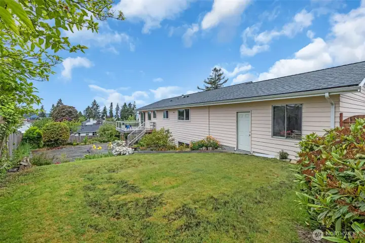 Upper Backyard grassy area with entry to the garage.