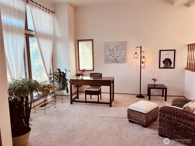 Living room with southern window view opens to dining room up above