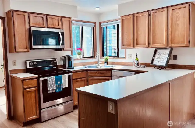 Full open kitchen with plenty of cabinets for storages, good lighting with two windows over the sink.