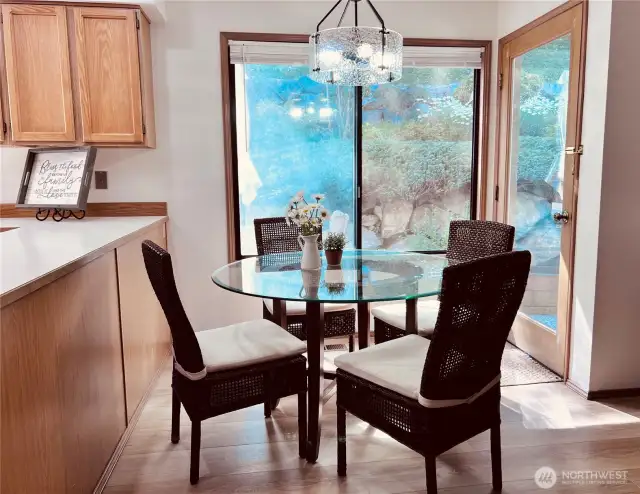 Breakfast sitting area besides open kitchen to enjoy a beautiful view of backyard with luscious plantings and landscape. New wood floorings.