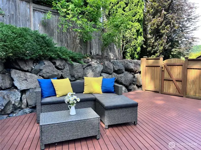 Decked patio. Wooden side gate towards north and opens to front of home.