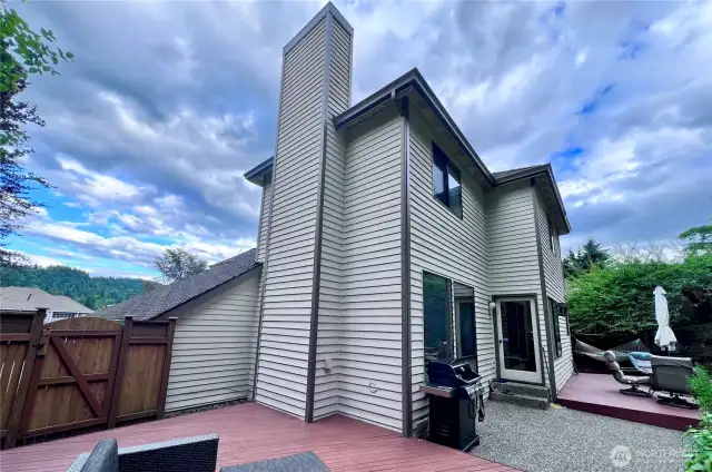 North side of home looking south with freshly painted siding on tall chimney.