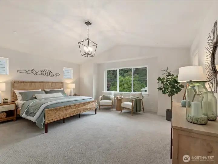 Beautiful primary suite with vaulted ceilings.