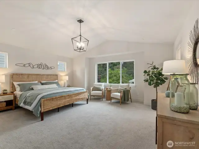 Beautiful primary suite with vaulted ceilings.