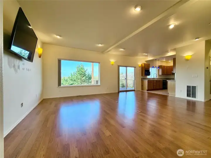 Open and airy great room with sliding door leading to the covered deck. Laminate flooring in great room and bedrooms.  Tile floors in entry, kitchen, and bathrooms. Wool carpet in stairs.