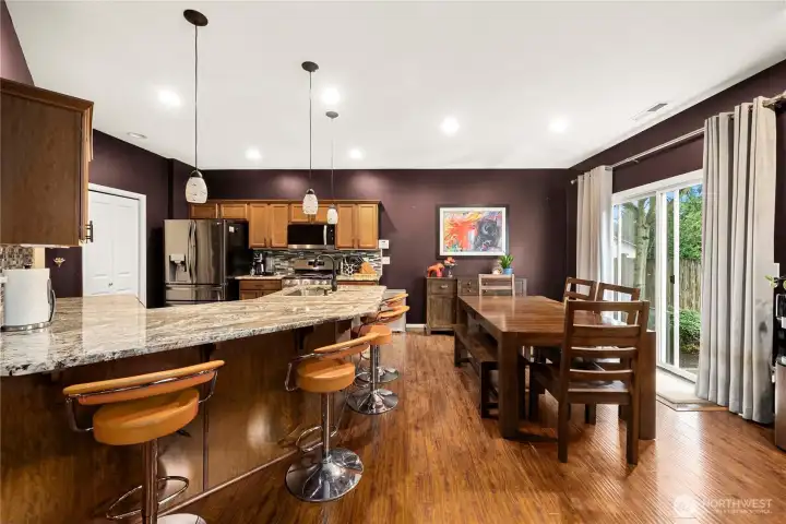Large kitchen with plenty of cabinet space, pantry and bar area.