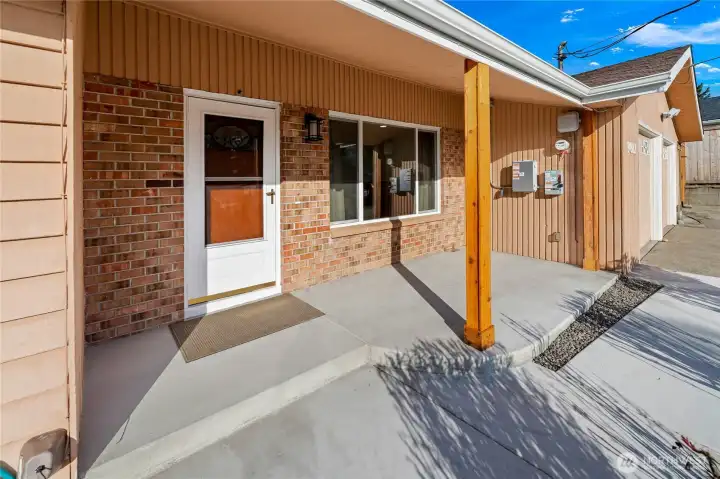 Brand new front porch and walkway highlighted by new cedar columns and newly poured concrete, creating a warm and inviting entry Brand new front porch and walkway highlighted by new cedar columns and newly poured concrete, creating a warm and inviting entry