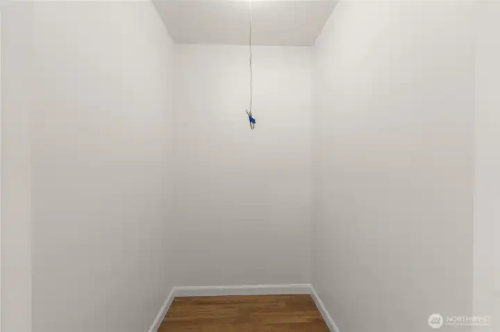 Spacious walk-in hallway closet providing ample storage for coats, linens, and household essentials