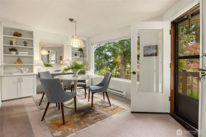 Beautiful built in hutch in the dining room is great for showcasing your special things and also doubles as a desk/work space.  The door leads out to your private covered deck. Another fabulous extention to your living space.