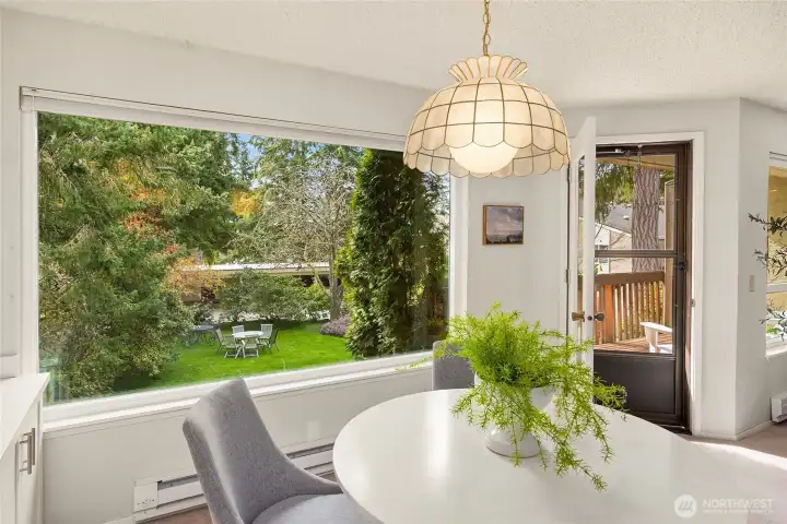 Big picture windows in dining and living frame the views of the gardens.