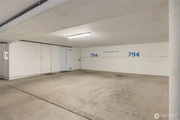 Two dedicated parking spaces in the community garage are very big. The private storage locker is shown here,  the door on the right.