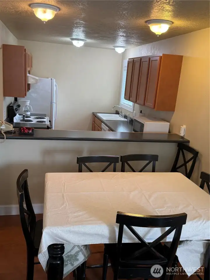 Looking into kitchen over the bar and table