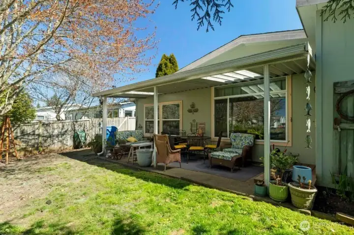 Another view of backyard and covered patio