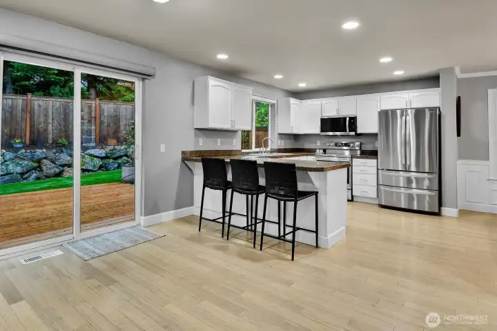 Kitchen Eating Area and Slider to Gorgeous New Multilevel Deck and Turf Backyard