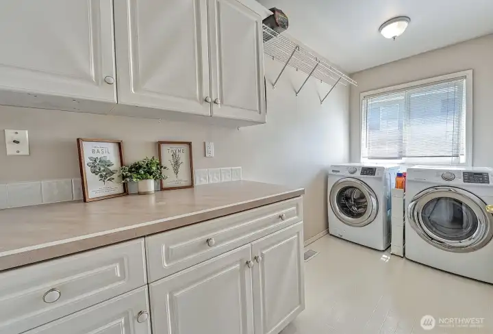 Laundry room with generous storage.