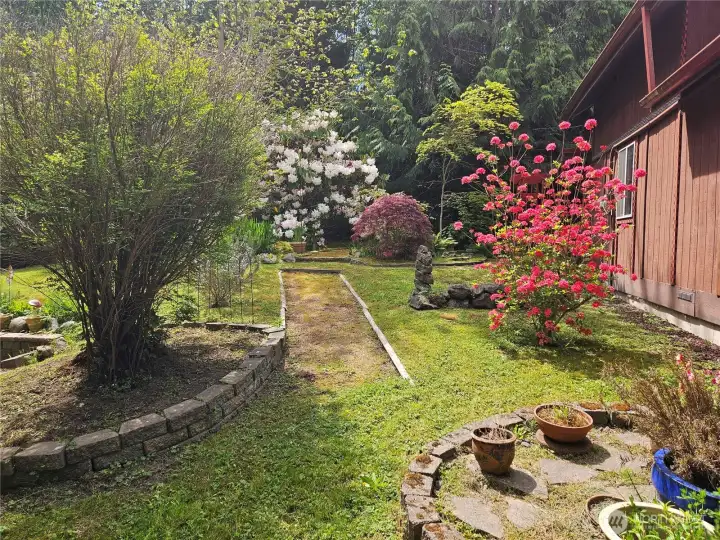 Beautiful landscaping with a creative flow to the secret garden off Bonus room with outside access Beautiful landscaping with a creative flow to the secret garden off Bonus room with outside access