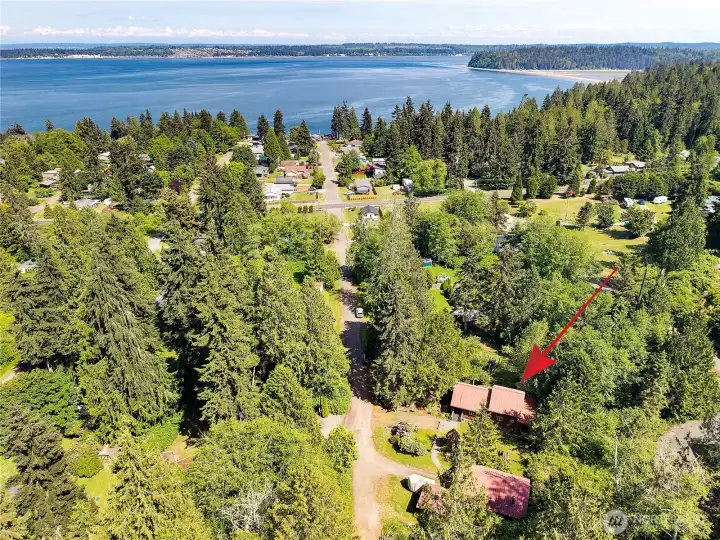 Aerial view of home near the beach. Trees provide privacy but offer potential for a partial water view with some removal. Aerial view of home near the beach. Trees provide privacy but offer potential for a partial water view with some removal.