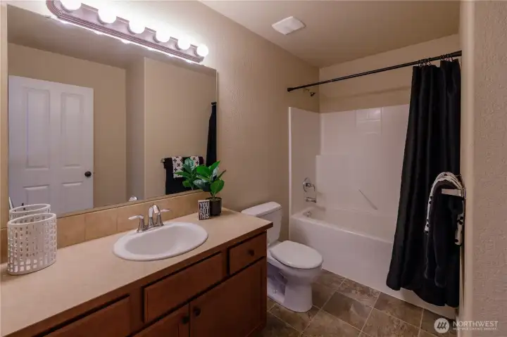 Second full bath in the home is near both the additional bedrooms and great room.