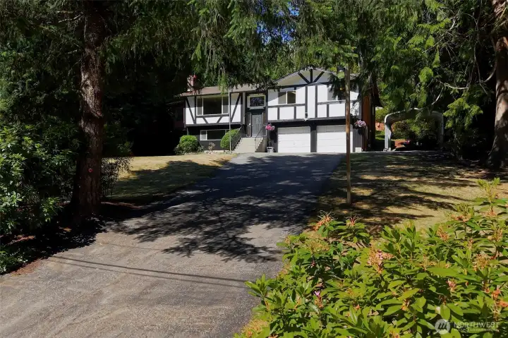 Welcome to this classic Tudor style home nestled on a shy acre in the heart of Silverdale.