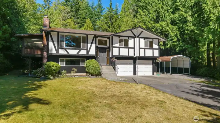 Timeless architecture and mature landscaping create unforgettable curb appeal. Large attached two car garage with additional storage space.