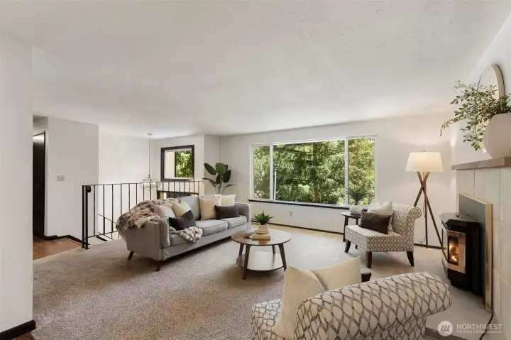 Bright and airy, the living room is bathed in sunshine through oversized windows, and thanks to the newer heat pump with air conditioning, you can enjoy the light without sacrificing comfort.