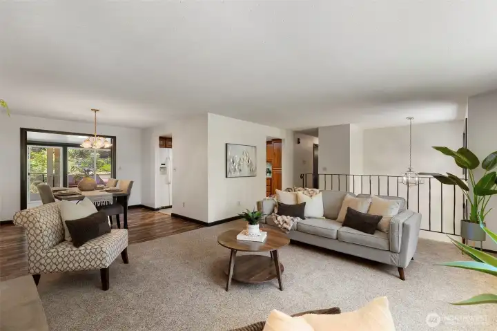 Spacious living room filled with natural light and centered around a cozy wood burning fireplace.