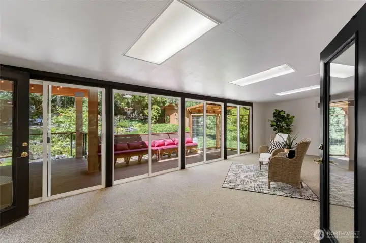 Bright and airy sunroom with skylights invites the outdoors in and provides the perfect space to relax year-round.