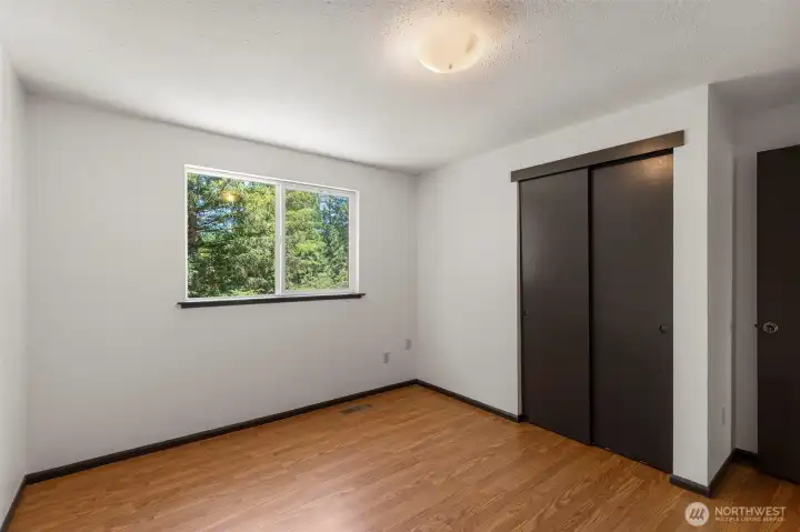 Secondary bedroom with peaceful views and abundant natural light.