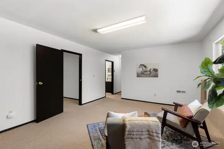 Versatile downstairs living area is ideal for multigenerational living, a home gym, or media room.