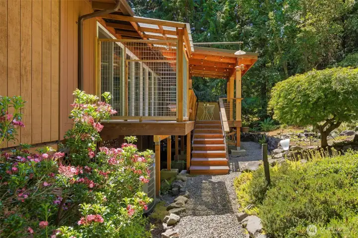 Architecturally designed covered deck seamlessly extends the living space while overlooking the peaceful backyard.