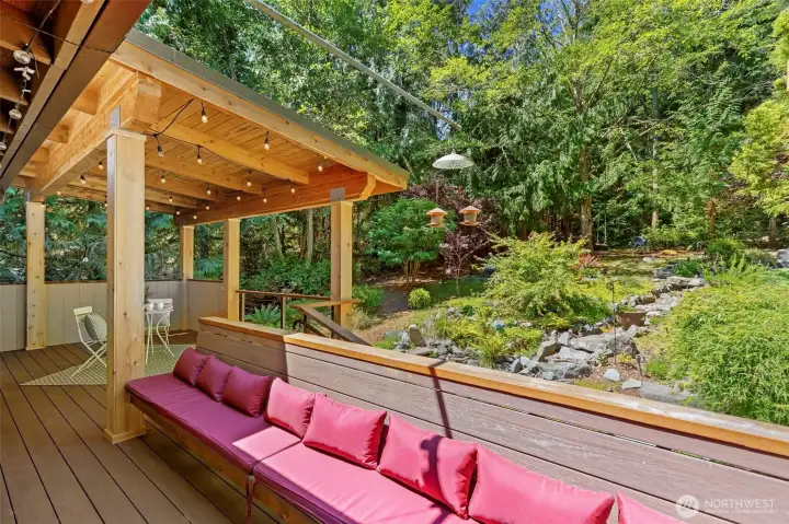 Built-in bench seating adds both style and functionality to the covered deck, making it easy to relax and enjoy the outdoors.