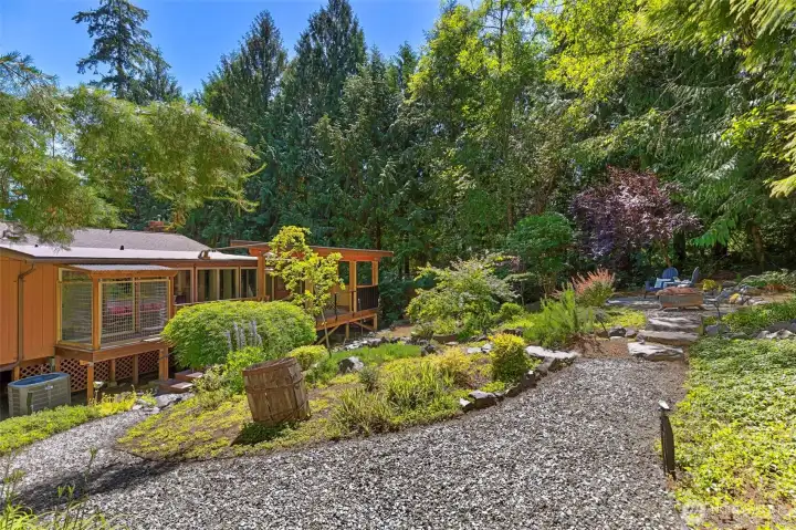 Tranquil koi pond creates a peaceful backyard retreat with a water feature that could be brought back to life.  The back deck also has a cattery.