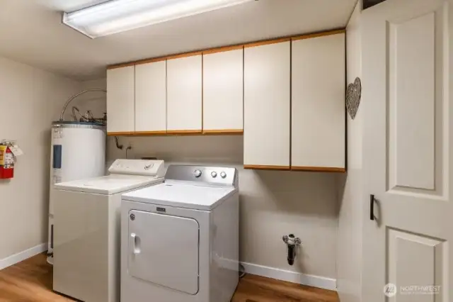 The utility room features tons of storage, including a large pantry.