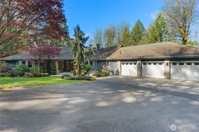 Bring all the toys to the 3 car garage, there is also ample parking space to the right on a gravel side driveway. AC, and generator are around that side as well.