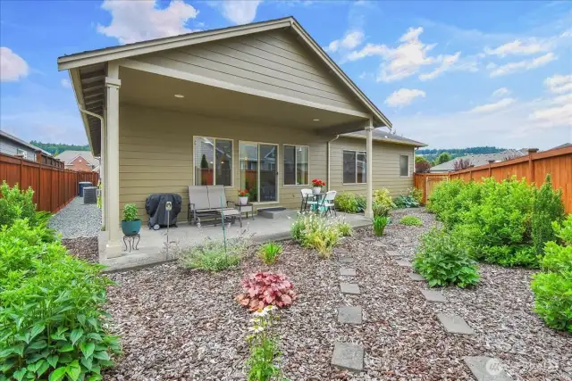 Fully fenced in back yard with covered patio