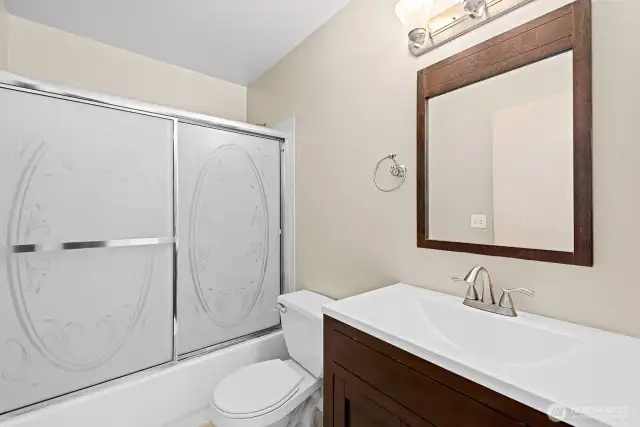 Guest Bath with Tile Floor and updated Vanity.