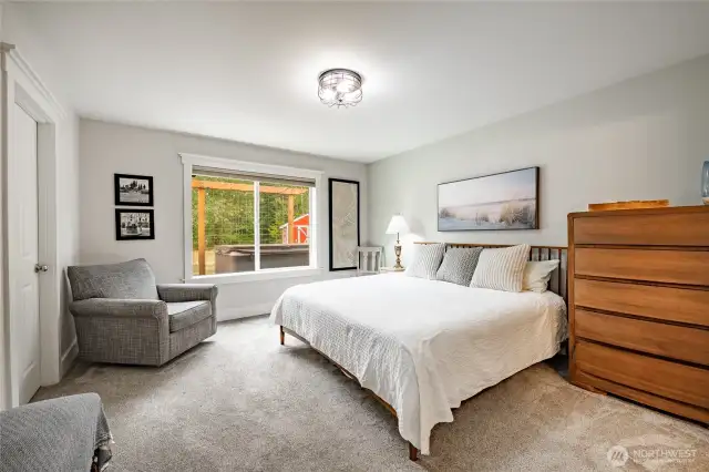 Primary bedroom on the main level with attached walk-in closet and full bathroom.