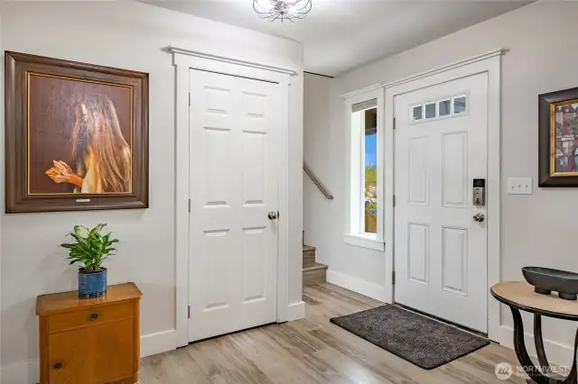 Front entry with guest closet and stairs leading to upstairs to additional 4 bedrooms, full bath and family room.