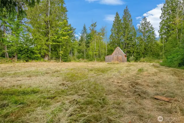This field leads up to a small cedar barn with loft. Past the barn brings you to a pond.
