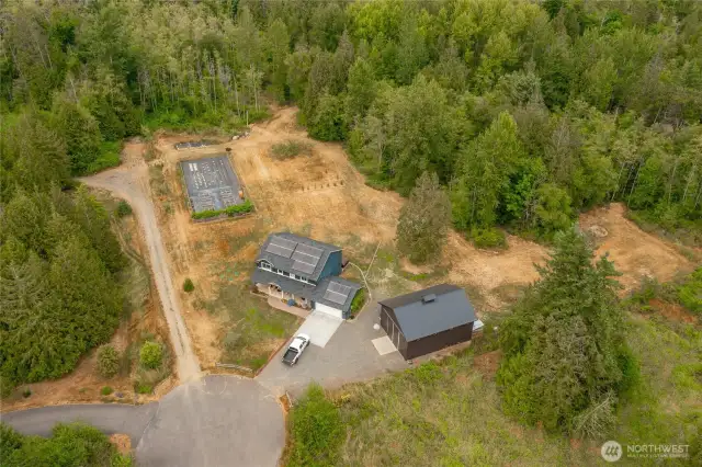 Ariel view of home, shop, fenced garden, orchard and acres of woods.
