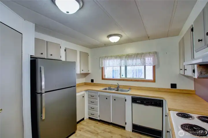 New flooring in the kitchen. Built-in stove top.
