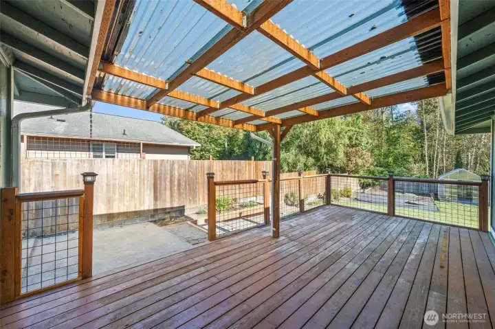 The back deck is partially covered and has fencing around it. Great for entertaining friends and loved ones or just relaxing with a morning coffee.